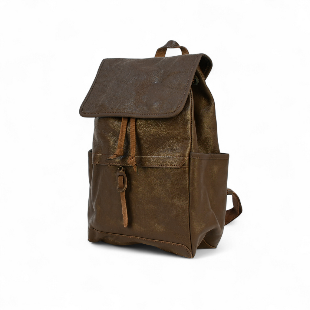 Brown modern rugged leather backpack in a forest setting