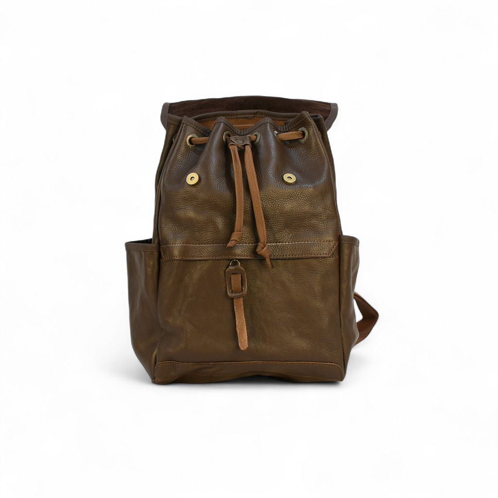 Brown modern rugged leather backpack in a forest setting