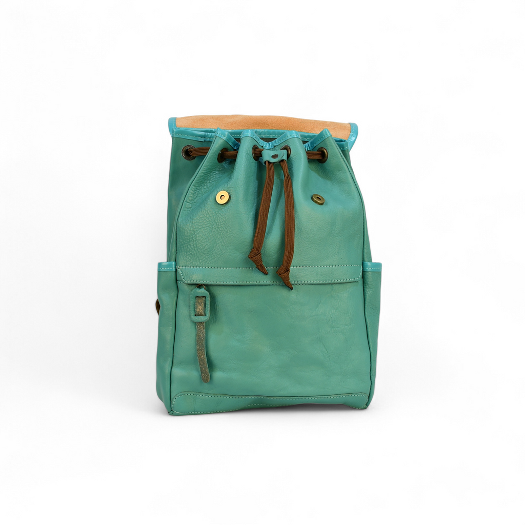Teal modern rugged backpack with brown straps on a wooden surface