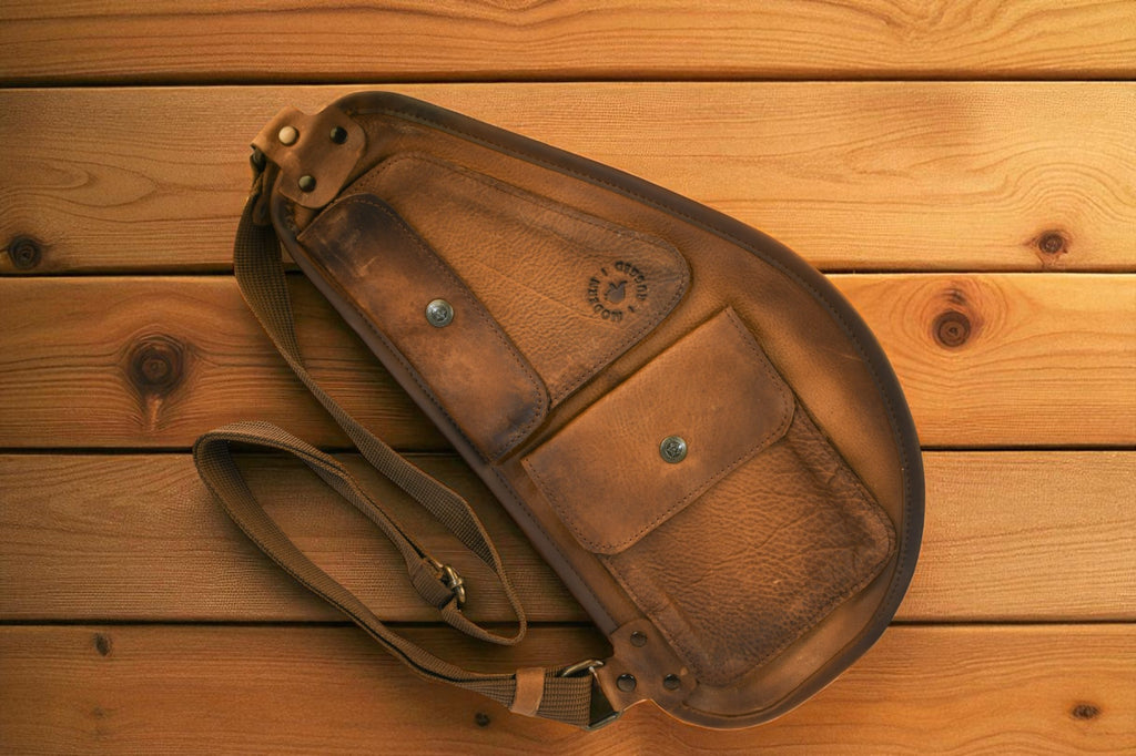 Brown Bovine Leather Slim Sling - Tan on a wooden surface