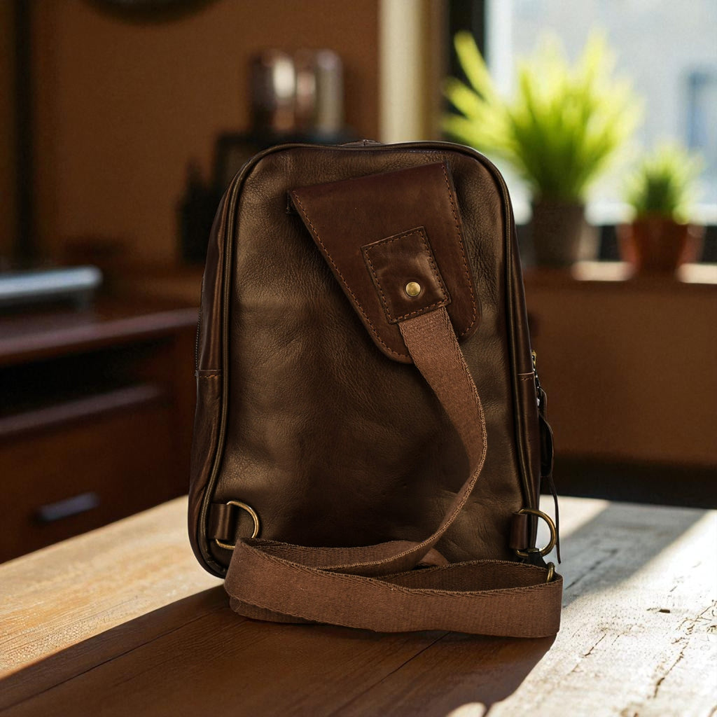 Brown leather bag on a wooden surface with a blurred indoor background