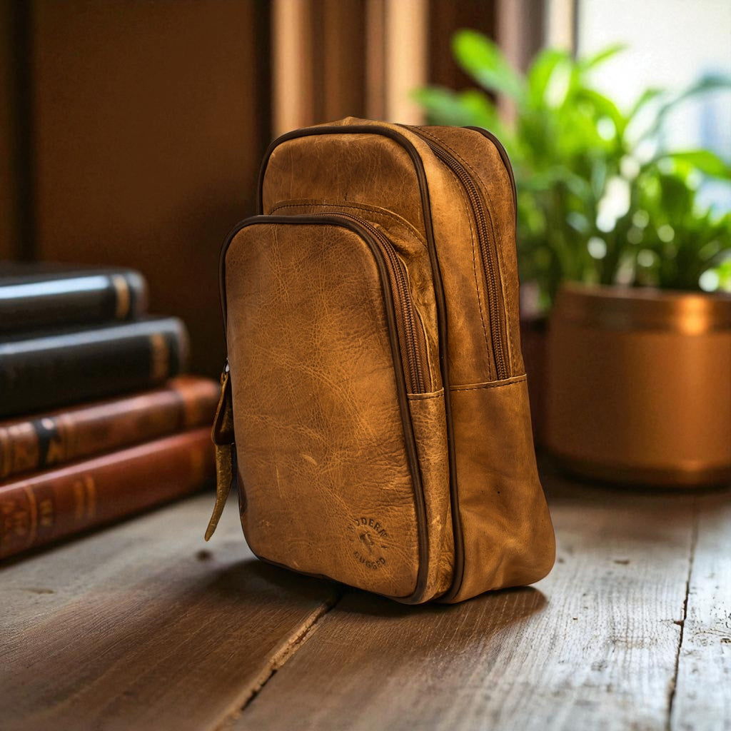 Brown leather bag on a wooden surface with books and a plant in the background