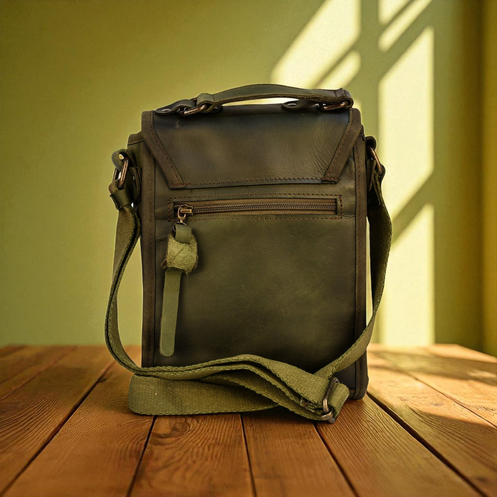 Green leather bag on a wooden surface with a green wall background