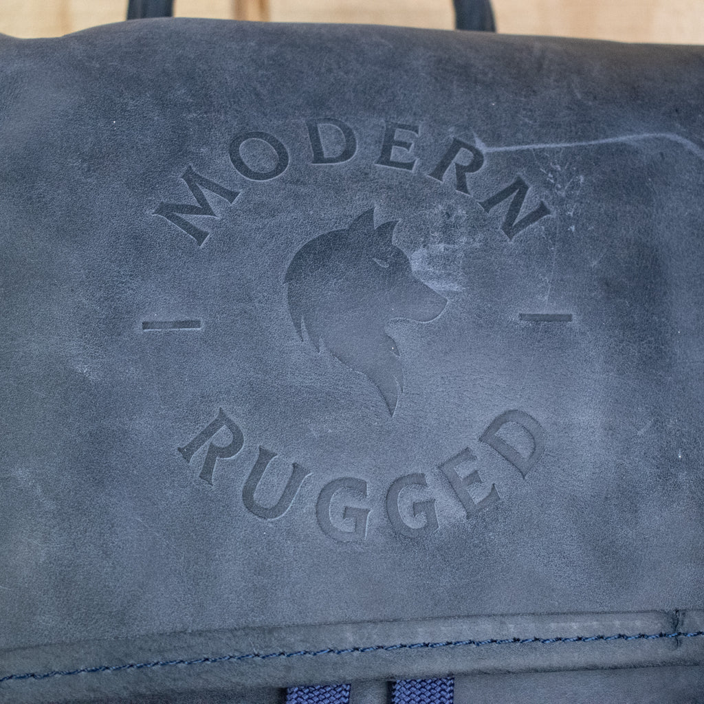 Leather Hide Backpack in Soft Navy (Weathered) with Modern Rugged Logo and lifetime warranty