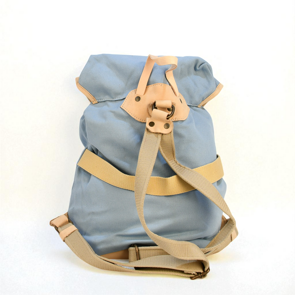 Light blue backpack with beige straps on a white background