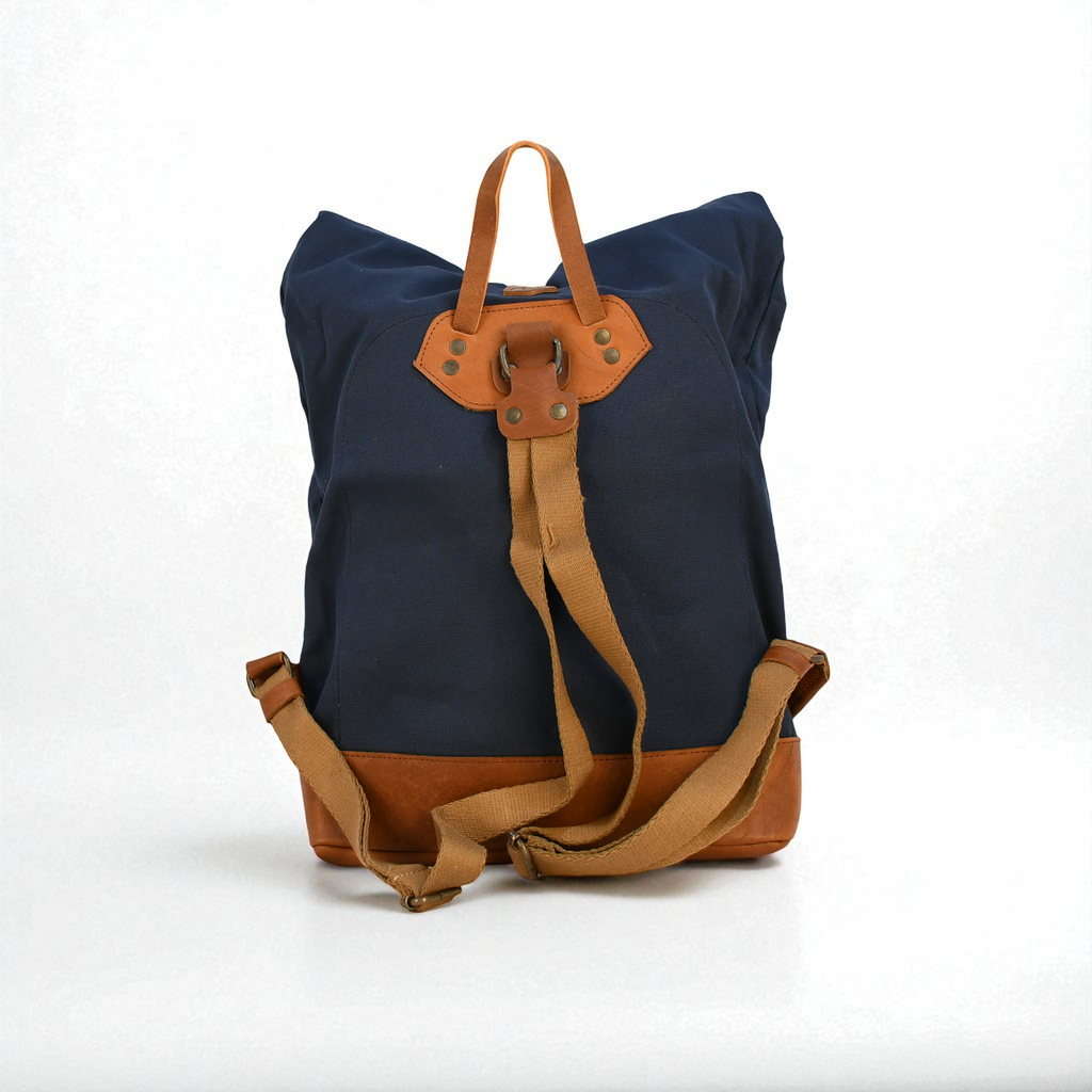 Navy blue backpack with brown leather straps on a white background